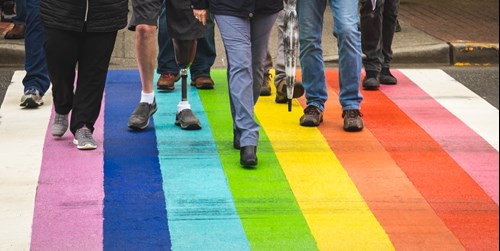 people walking on rainbow crosswalk; Photo by Greg Rosenke on Unsplash
